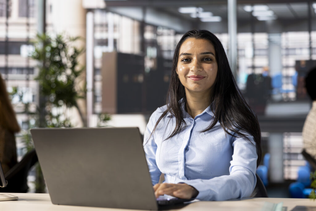account executive multitasking at her desk working on business goals